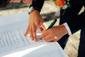 a picture of a person signing a document